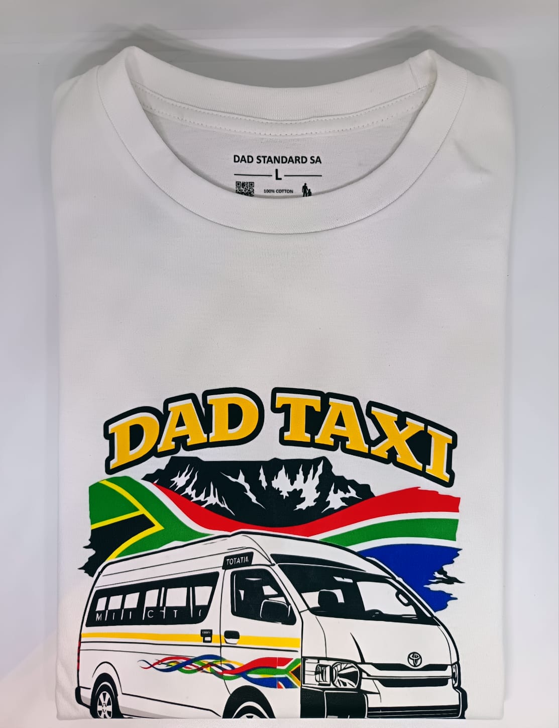 White t-shirt with 'Dad Taxi' graphic design featuring a van and South African flag on a white background.