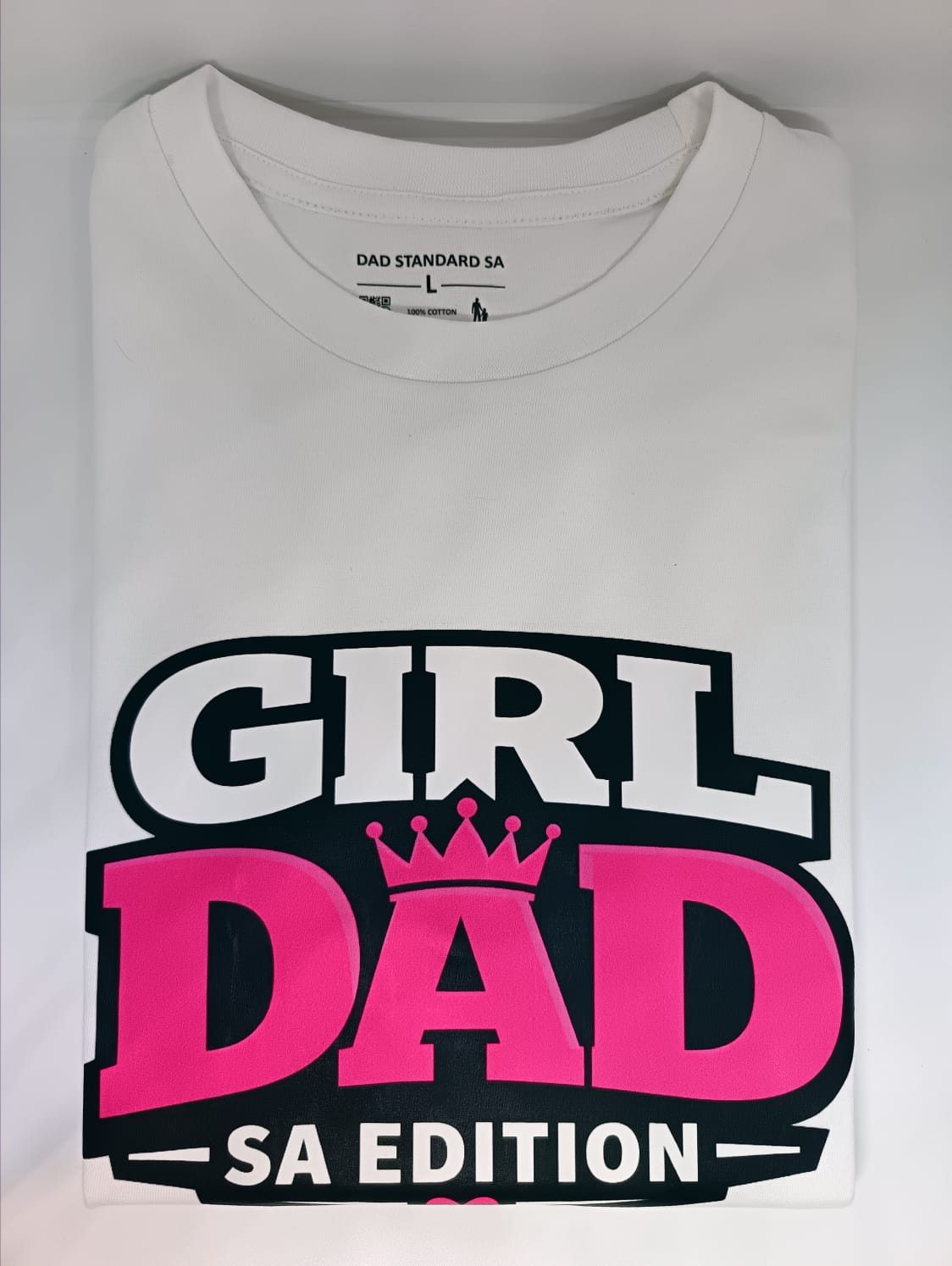 White t-shirt with 'Girl Dad SA Edition' text design on a light gray background